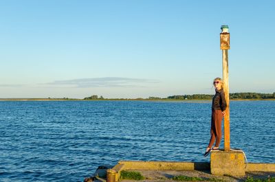 Scenic view of lake against clear blue sky