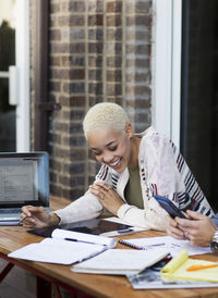 Business people talking while sitting in office balcony