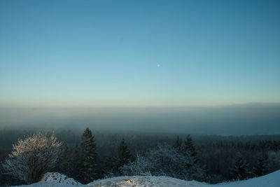 Scenic view of snow covered landscape against clear sky
