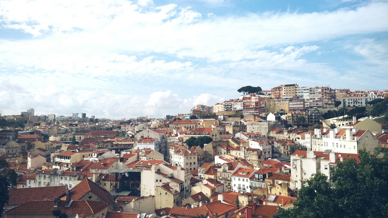 building exterior, architecture, built structure, crowded, cityscape, city, residential district, residential structure, sky, residential building, roof, high angle view, house, townscape, cloud - sky, town, cloud, day, outdoors, community