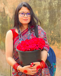 Portrait of young woman holding flower