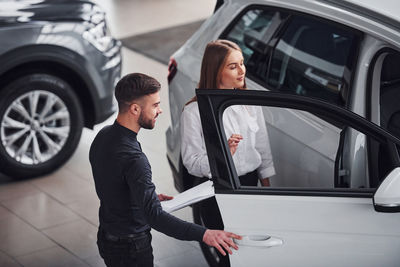 Side view of young woman in car