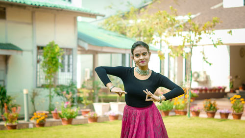 Portrait of a smiling young woman standing outdoors