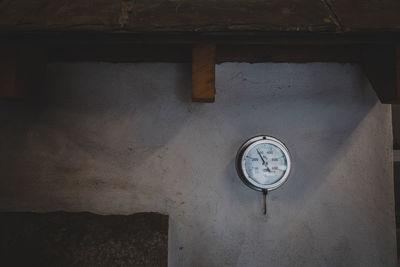 Low angle view of clock on wall in old building