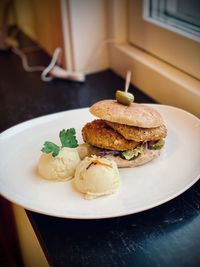 High angle view of fish burger in plate on table