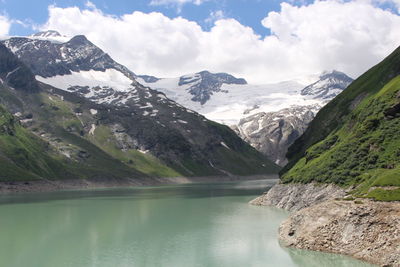 Scenic view of lake and mountains against sky