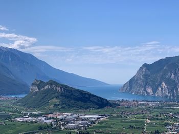 Scenic view of townscape by mountains against sky