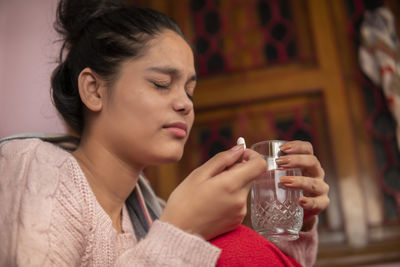 Close-up of young woman having drink