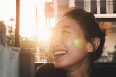 Portrait of smiling young woman looking away