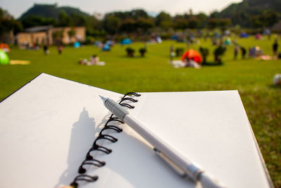 Close-up of open book on field