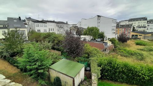 High angle view of buildings and trees against sky