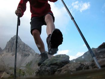 Low section of man walking on mountain