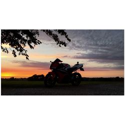 View of tractor on field at sunset