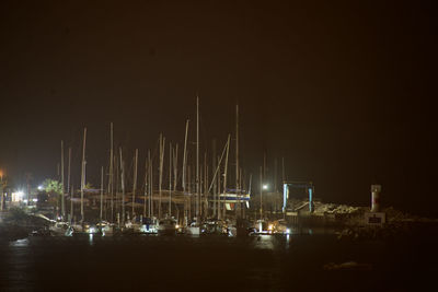 Sailboats in sea against sky at night