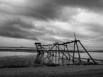 Lifeguard hut on beach against sky