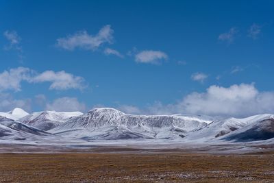 Scenic view of snowcapped mountains against sky