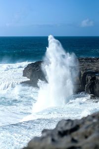 Waves breaking against sea