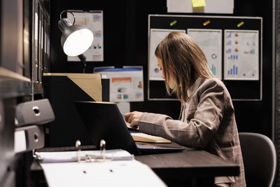 Young woman using laptop at office