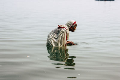 Reflection of man in lake