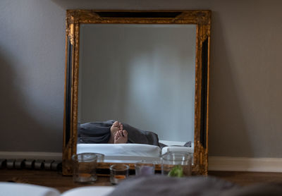 Reflection of person foots seen in mirror