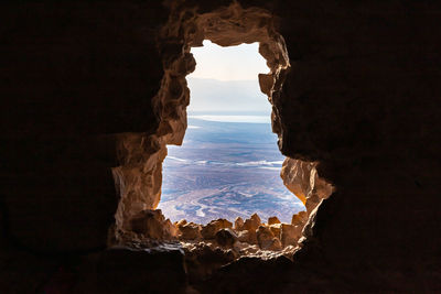 Scenic view of landscape seen through cave