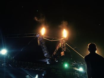 Low angle view of illuminated people at night