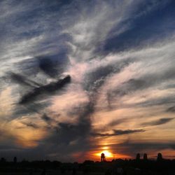 Silhouette of landscape against cloudy sky