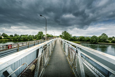 Bridge over river against sky. loneliness concept