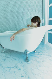 Woman sitting in bathtub 