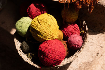 High angle view of colorful wool balls in basket