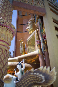 Statue outside temple against building