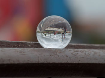 Close-up of crystal ball on wooden table