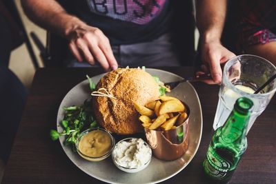 Midsection of man having food on table