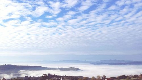 Scenic view of mountains against cloudy sky