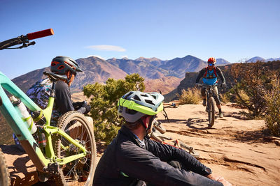 Mountain bikers on the whole enchilada trail in moab, utah.