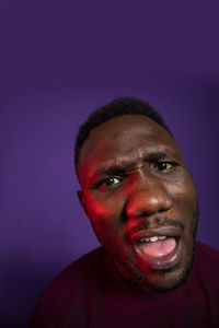 Portrait of a smiling man against blue background