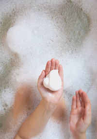 High angle view of baby feet in bathroom