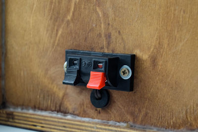 Close-up of telephone booth on table against wall