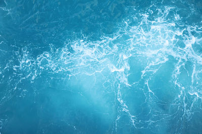 Sea waves in ocean wave splashing ripple water. blue water background.