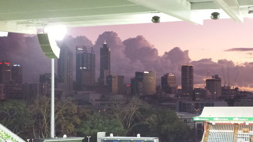 Skyscrapers in city at dusk