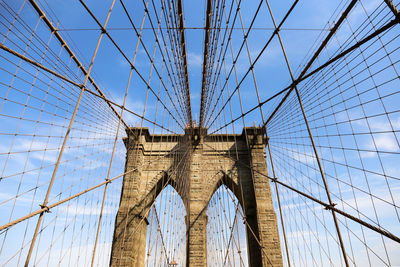 Low angle view of brooklyn bridge against blue sky