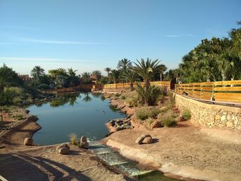 Scenic view of lake against clear blue sky