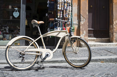 Bicycle parked on street by building