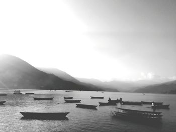 Boats moored in sea against sky