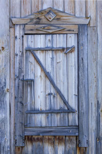 Spare wooden door in an old wooden house. front view.