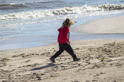 Full length of child walking at beach