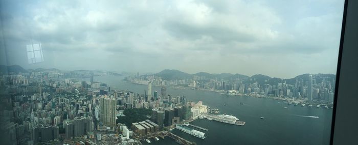 High angle view of cityscape against cloudy sky