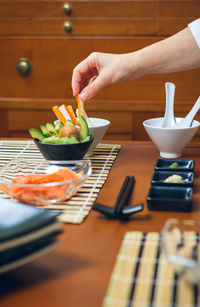 Midsection of person preparing food on table
