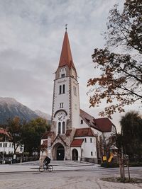 View of church and buildings against sky