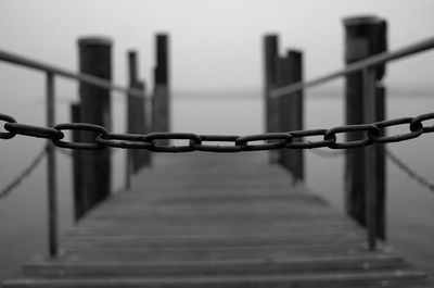 Close-up of metal fence against sky